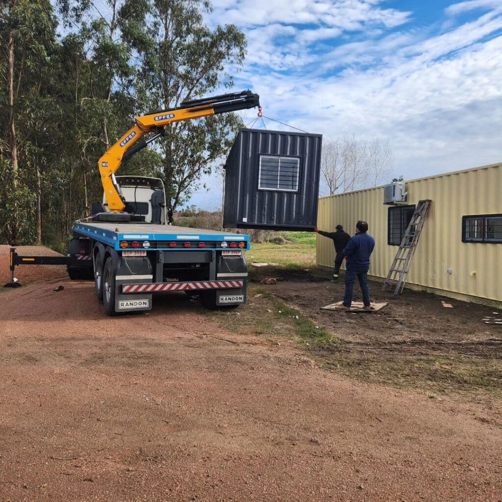 
A truck moving a container house to the land where the house will be placed